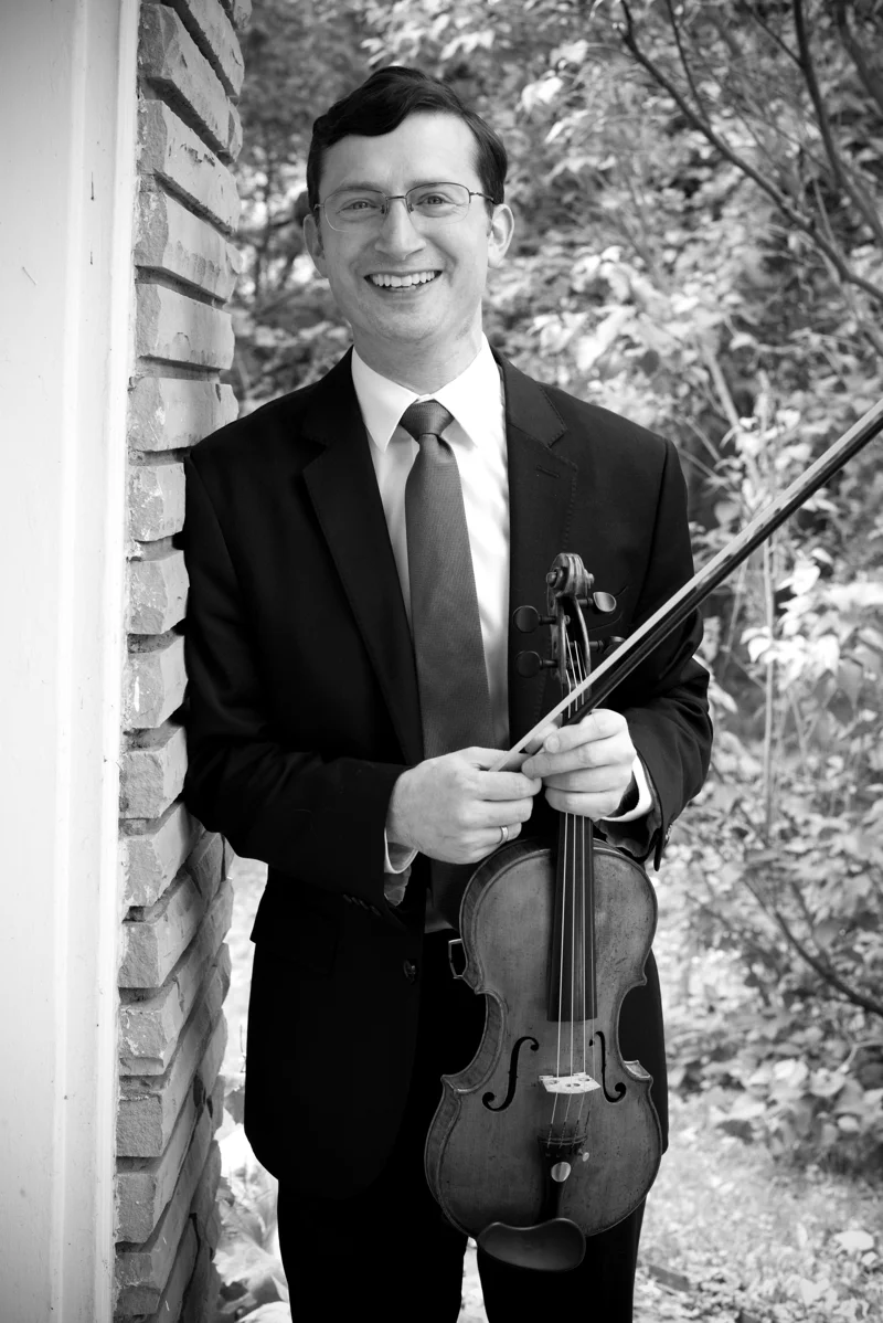 Jeremy Black outdoors with his violin